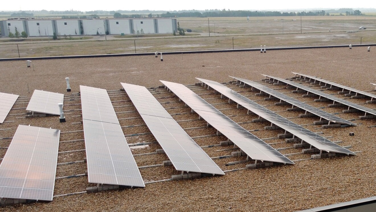 A photo of solar panels on the top of a fulfillment center in Edmonton, Canada.